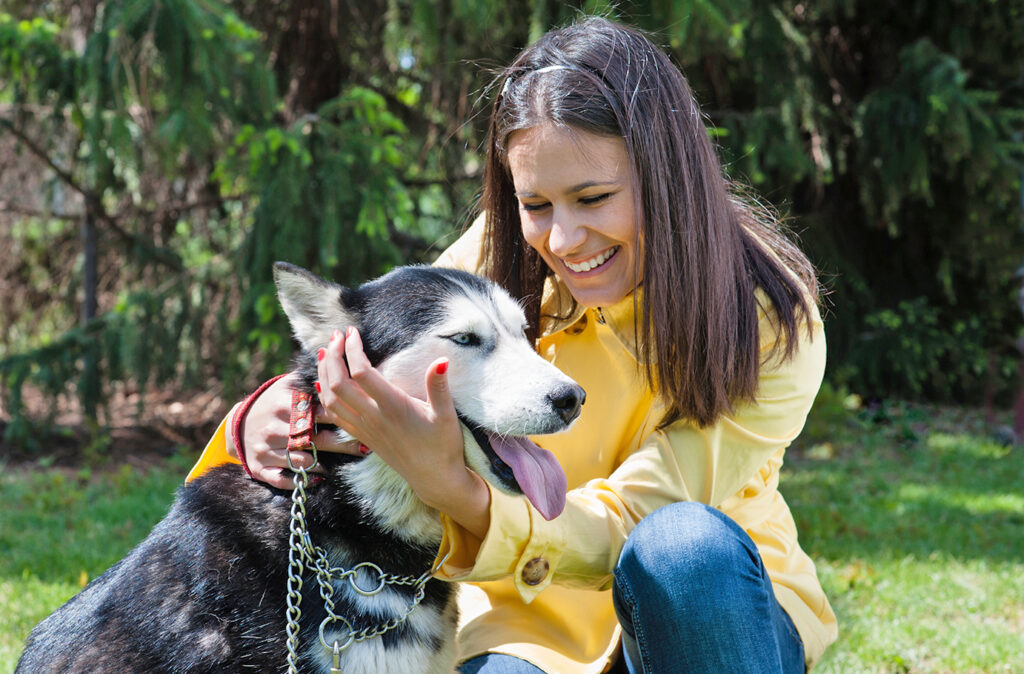 girl huging her dog siberian husky