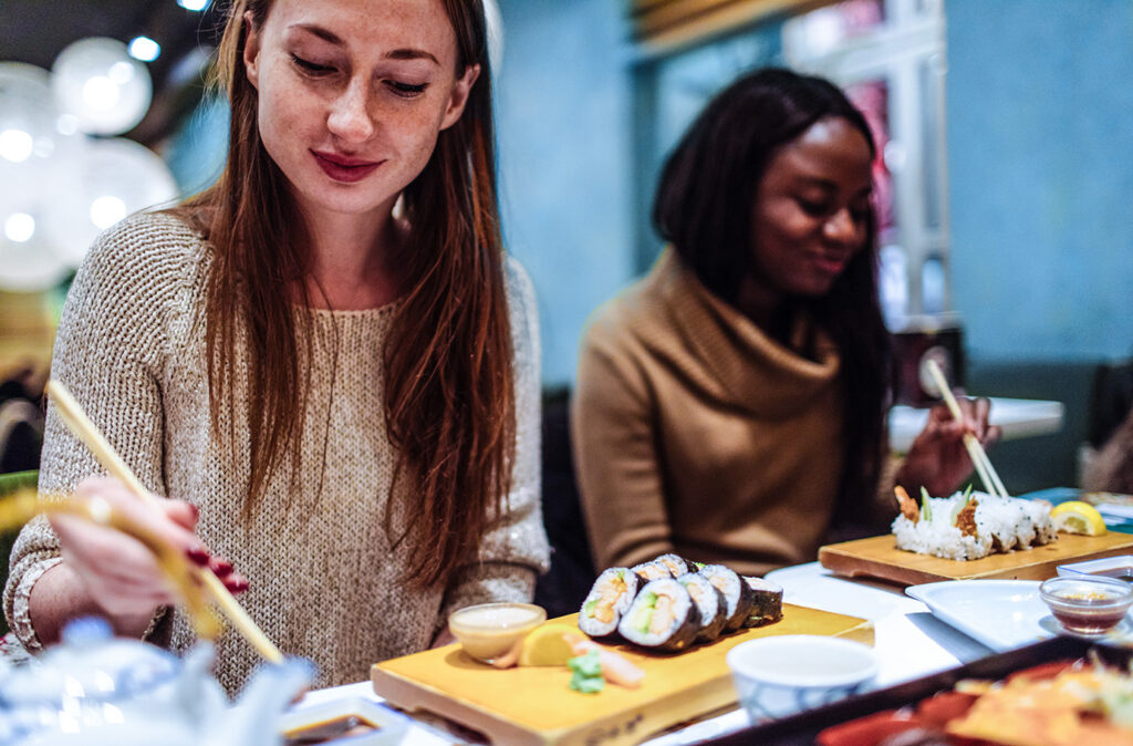 Multi-ethnic group of female friends who enjoy together in each other's company, during dinner in a Chinese restaurant