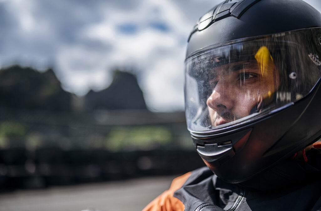 Close-up shot of motorist with his helmet on.