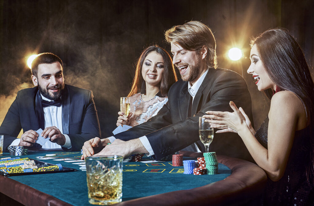 Upper class friends gambling in a casino. Two men in suits and two young women in dresses. Smoke. Casino. Poker