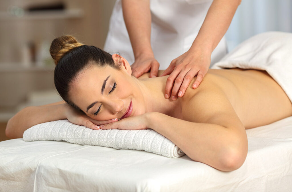 Relaxed woman receiving a back massage in a spa salon