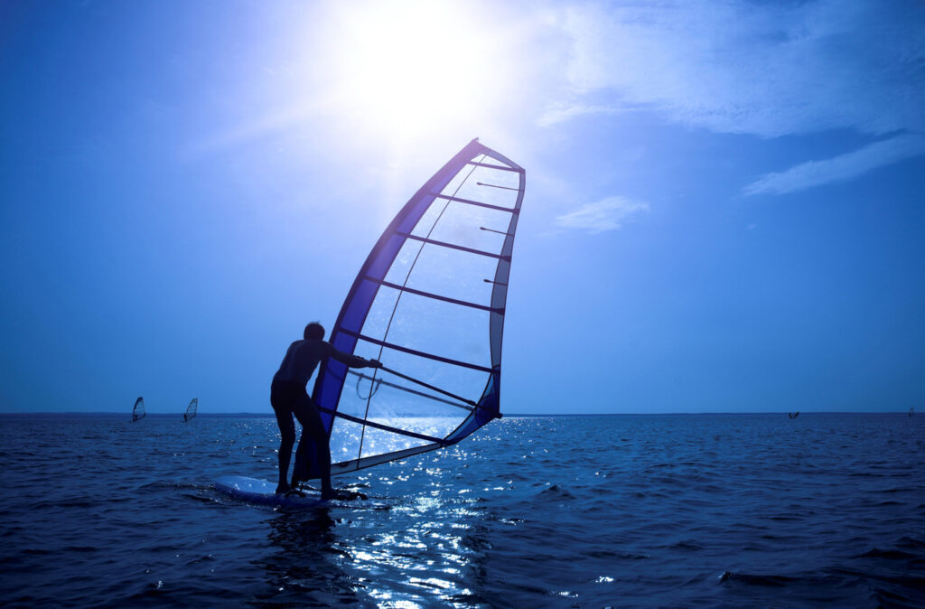 Surfer on sunshine on waves