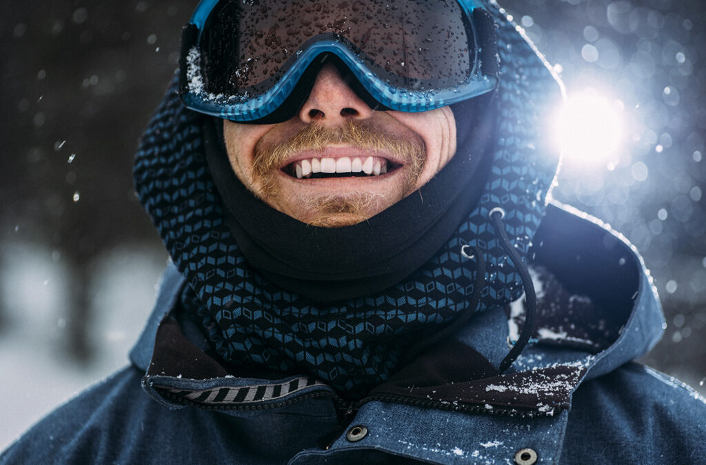 Young snowboarder smiling and posing for the camera