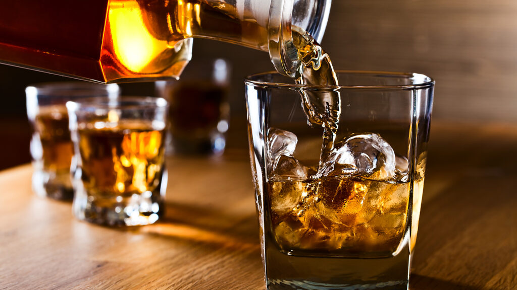 whiskey and natural ice on old wooden table