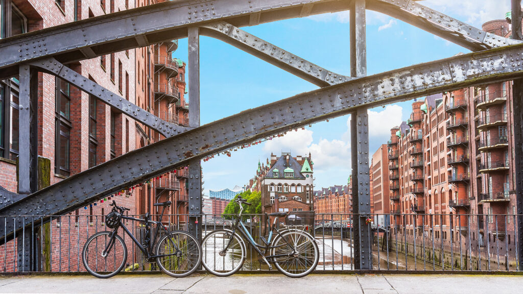 bicycles parked against iron handrail on a bridge in the old warehouse district Speicherstadt in Hamburg, Germany