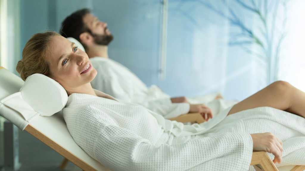 Happy married couple relaxing at wellness spa resort