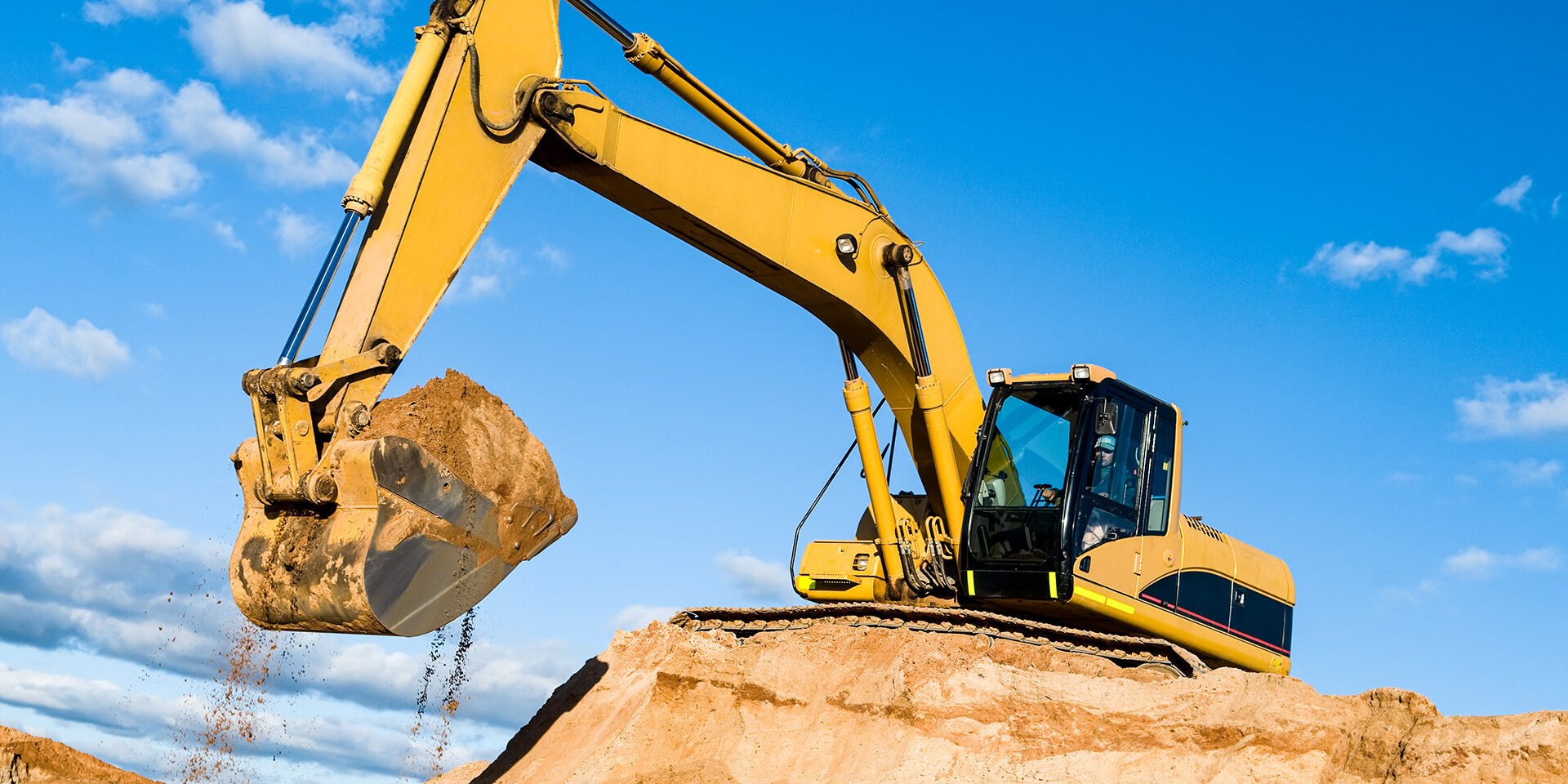 track-type loader excavator at sand quarry excavator loader machine during earthmoving works outdoors at construction site