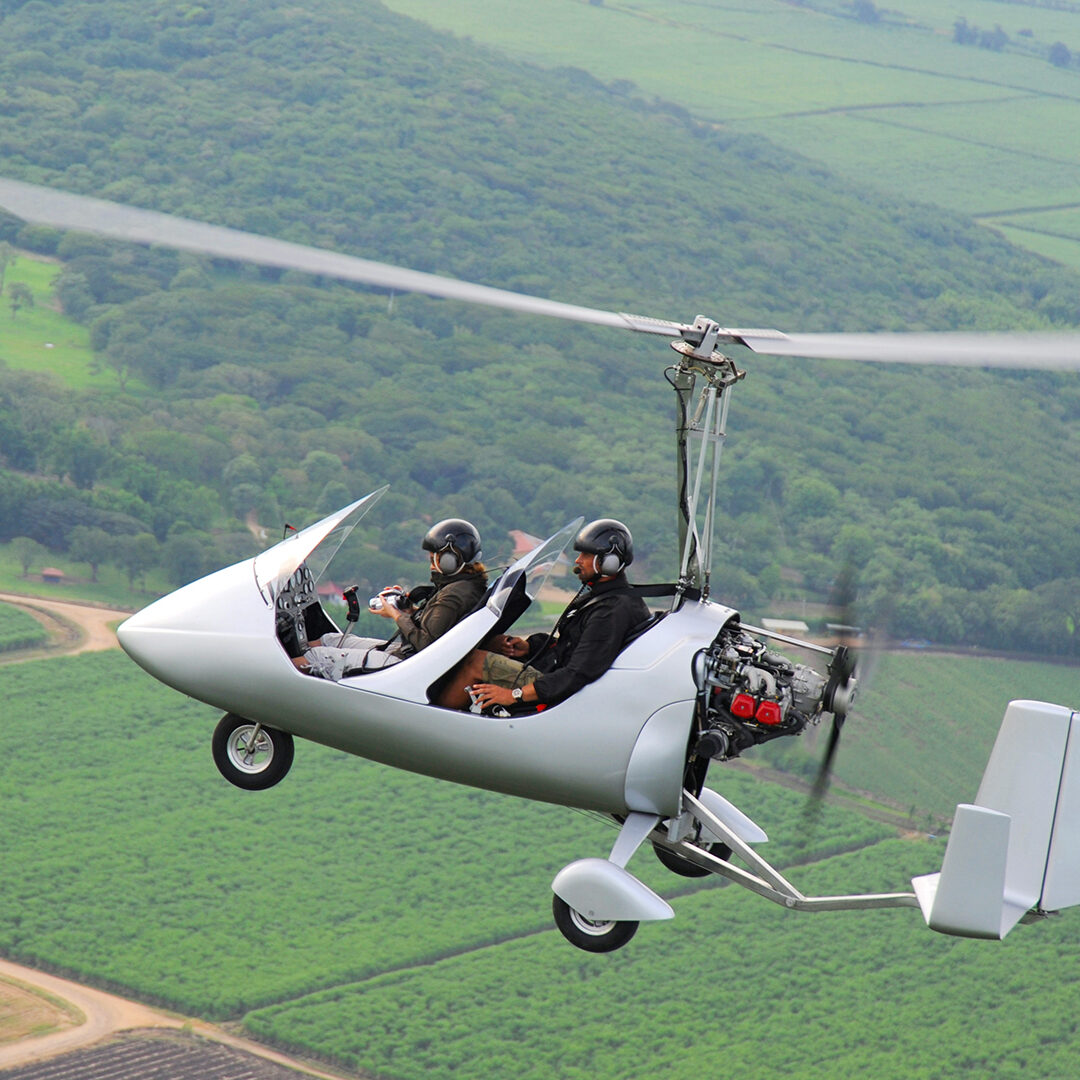 Autogyro flying over the tropical landscape