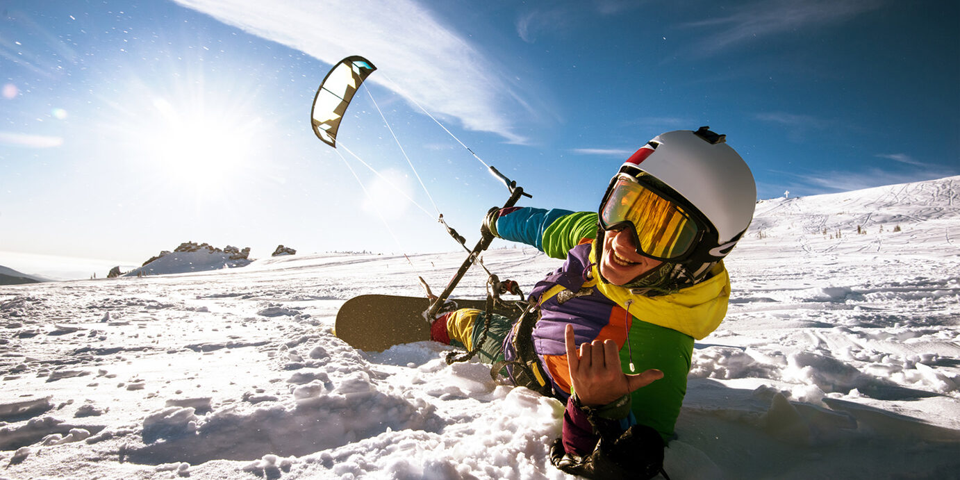 Snowboarder skydives on blue sky backdrop in mountains snowfall Bright color Snowboarder skydives on blue sky backdrop. Sheregesh, Siberia, Russia