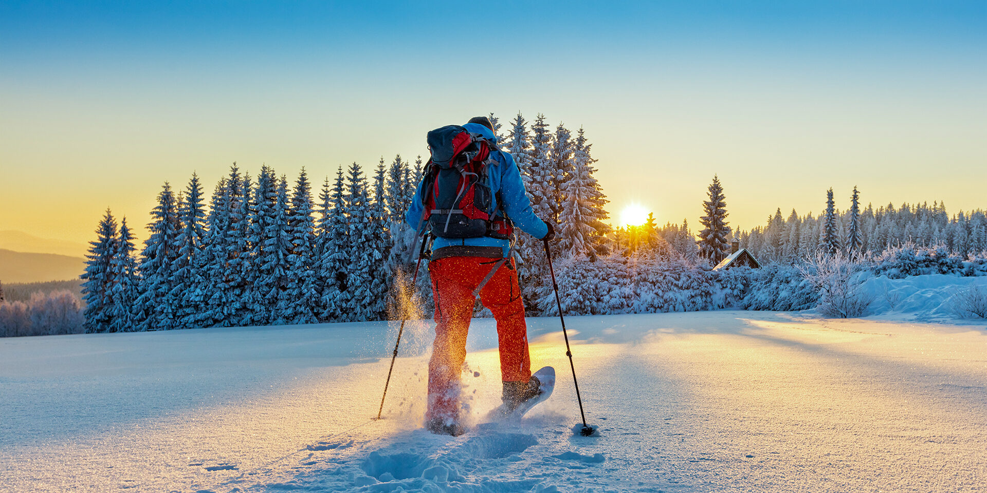 Snowshoe walker running in powder snow Snowshoe walker running in powder snow with beautiful sunrise light. Outdoor winter activity and healthy lifestyle