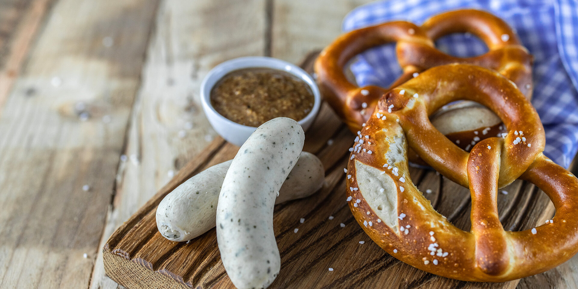 Beer Fest food. Bavarian meal . White sausages, brezel and sweet mustard on wooden table Beer Fest food. Bavarian meal . White sausages, brezel and sweet mustard on wooden table