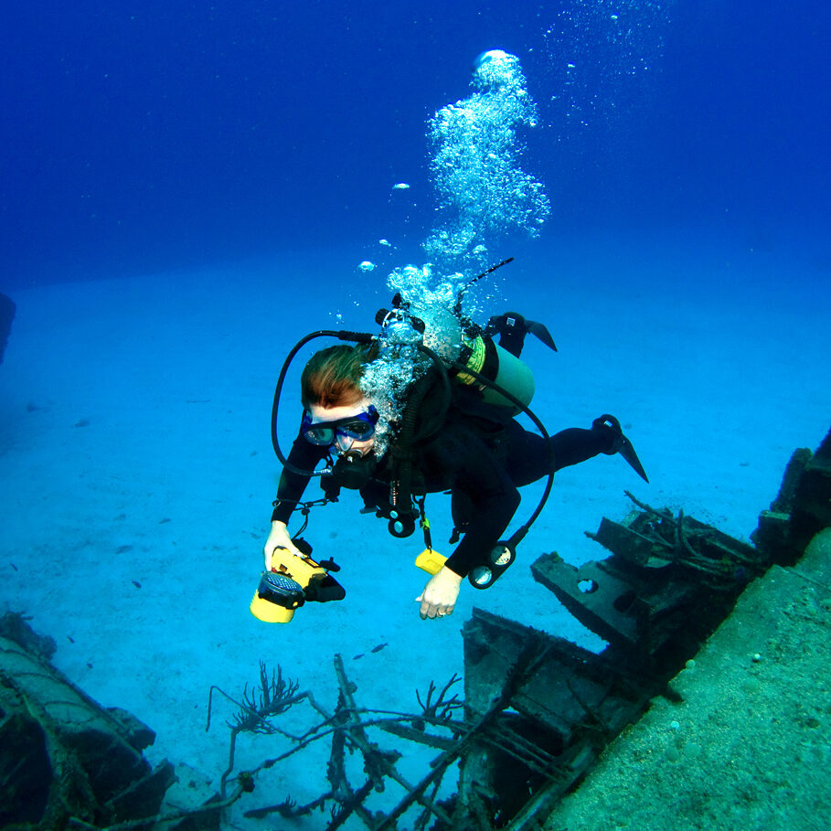 Diver photographing a Sunken Shipwreck in Cayman Brac