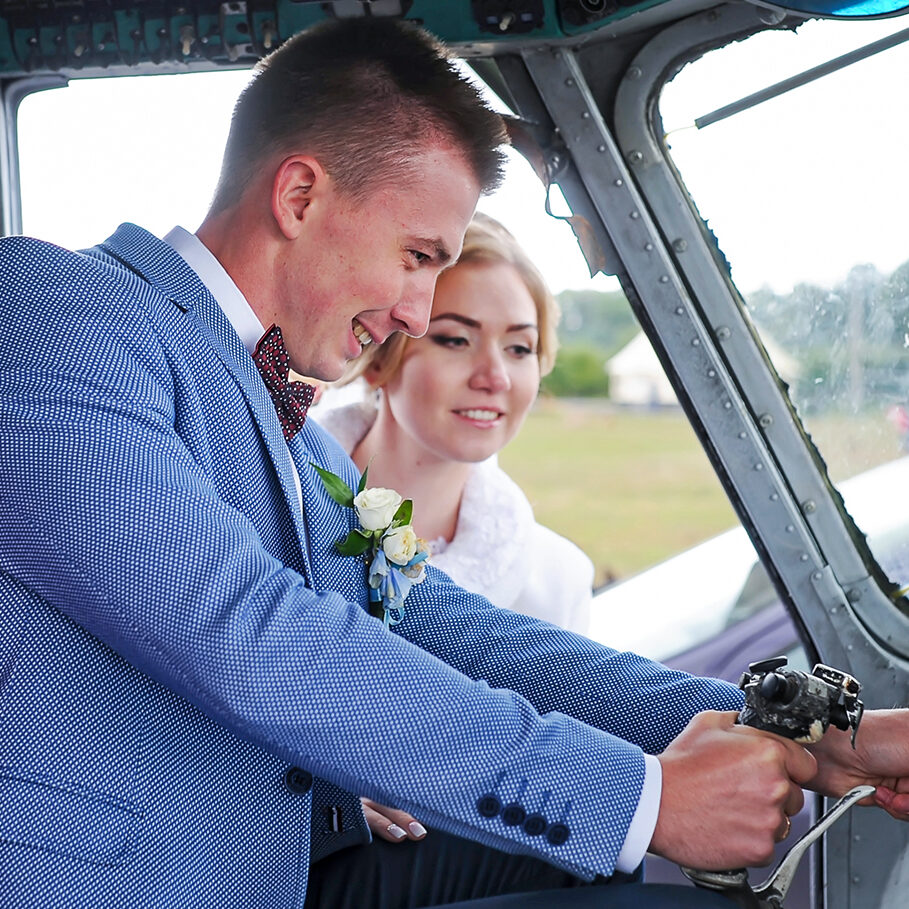 Happy wedding couple bride and groom riding helicopter. Closeup.