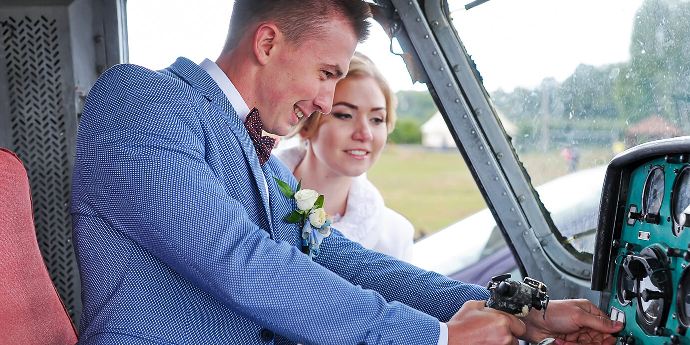 Happy wedding couple and helicopter Happy wedding couple bride and groom riding helicopter. Closeup.