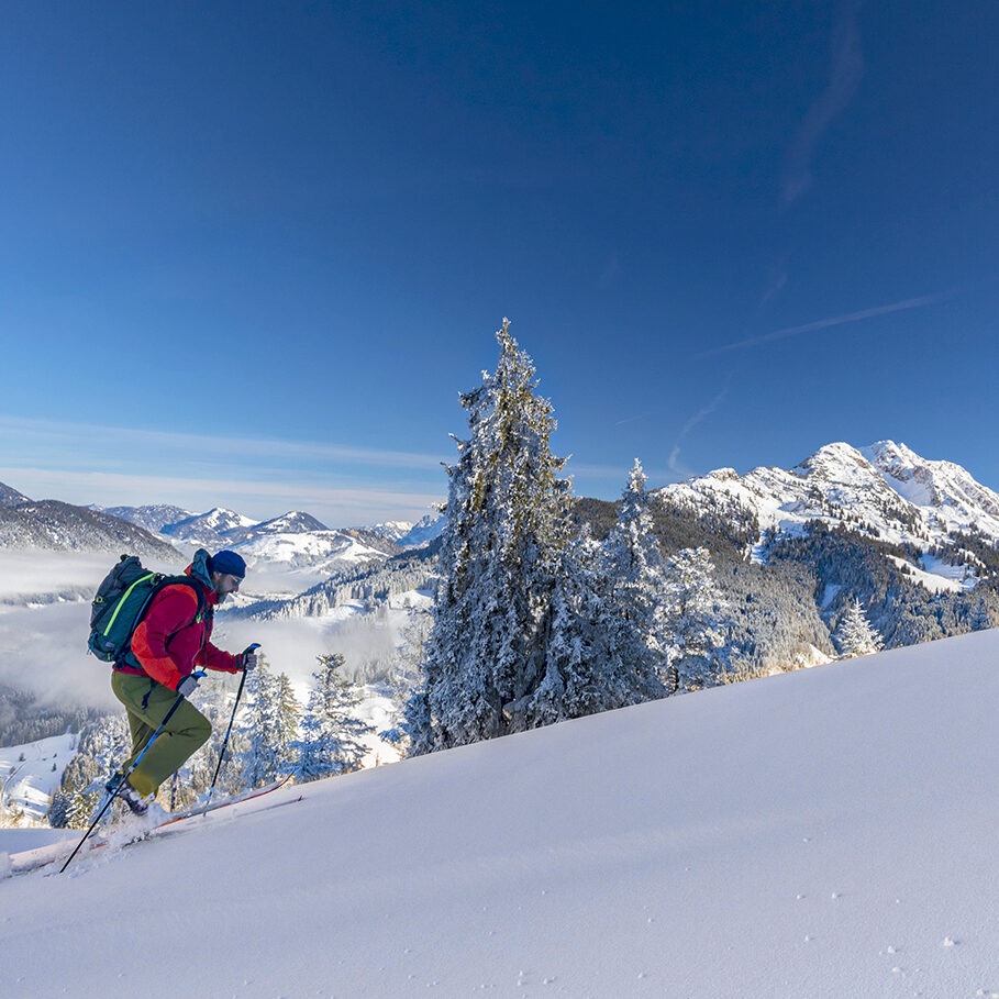 skier ascending a mountain in winter in the Alps