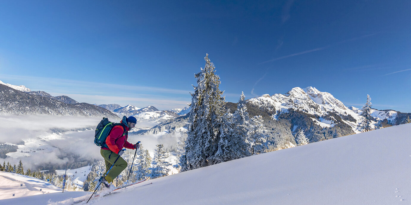 Back country Ski touring in the Austrian alps skier ascending a mountain in winter in the Alps