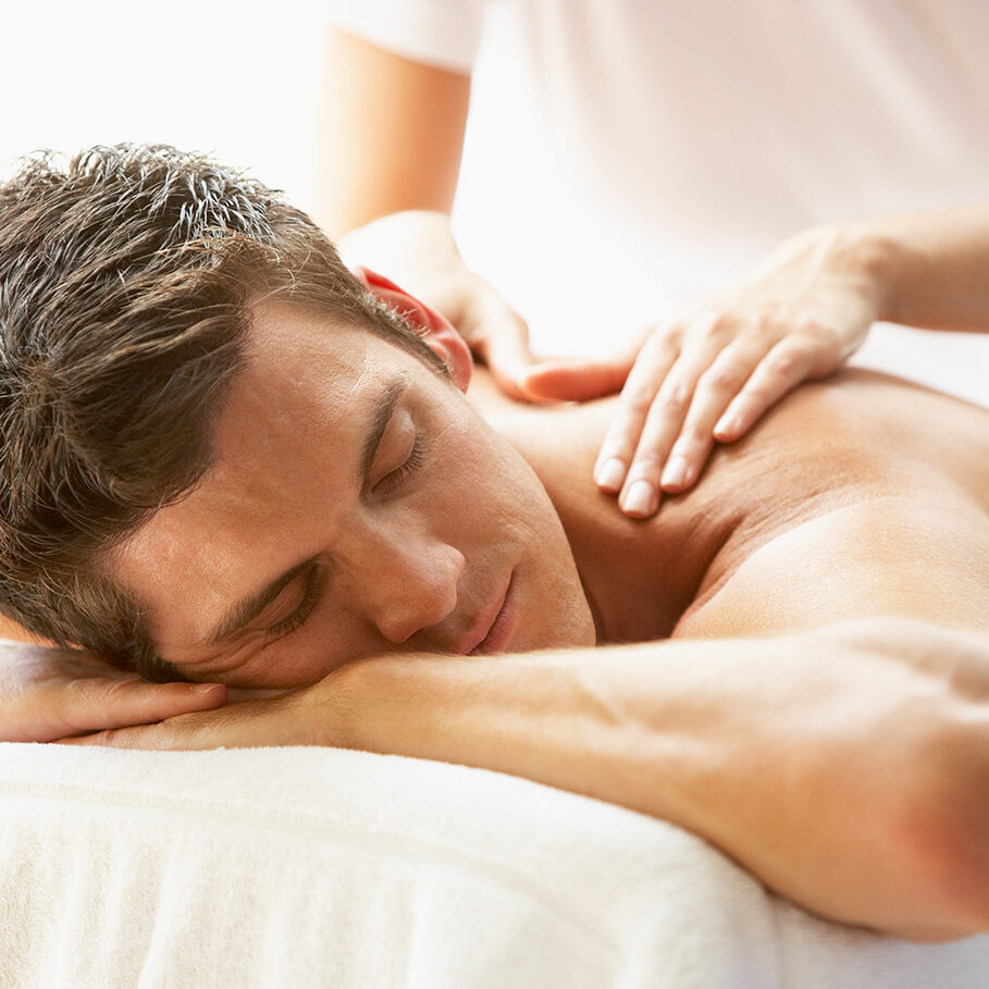 Young Man Enjoying Massage At Spa