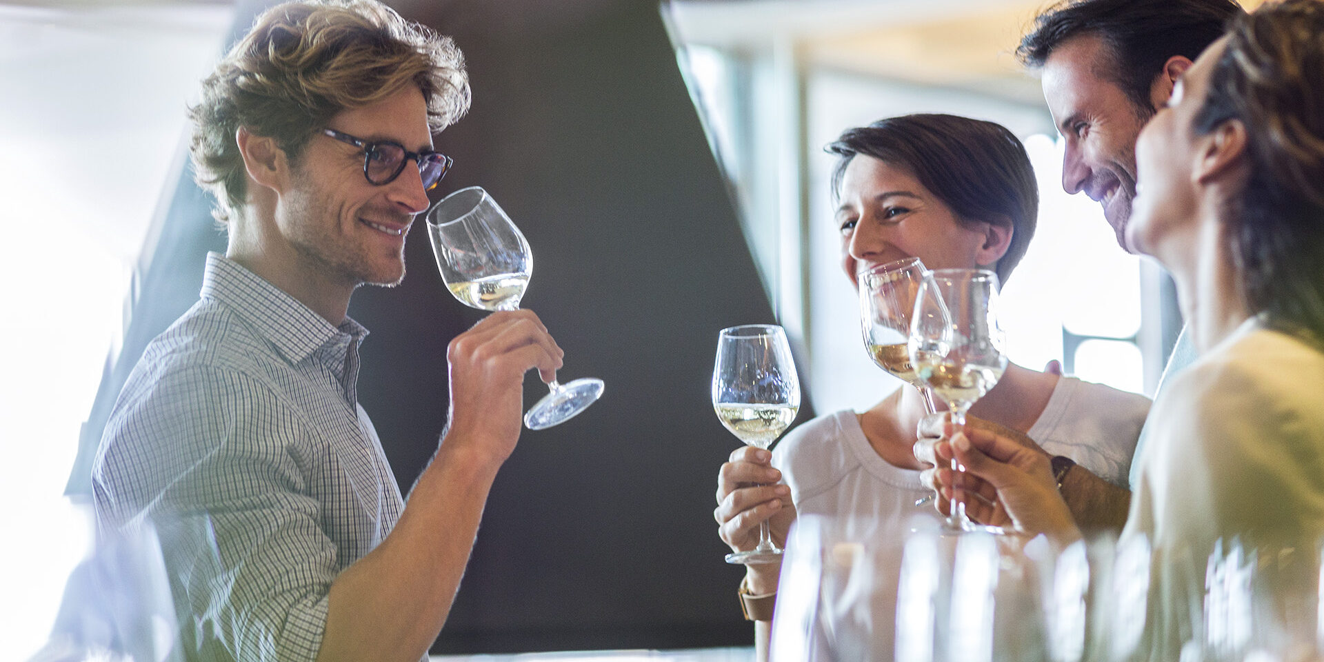 Friends wine tasting in winery tasting room