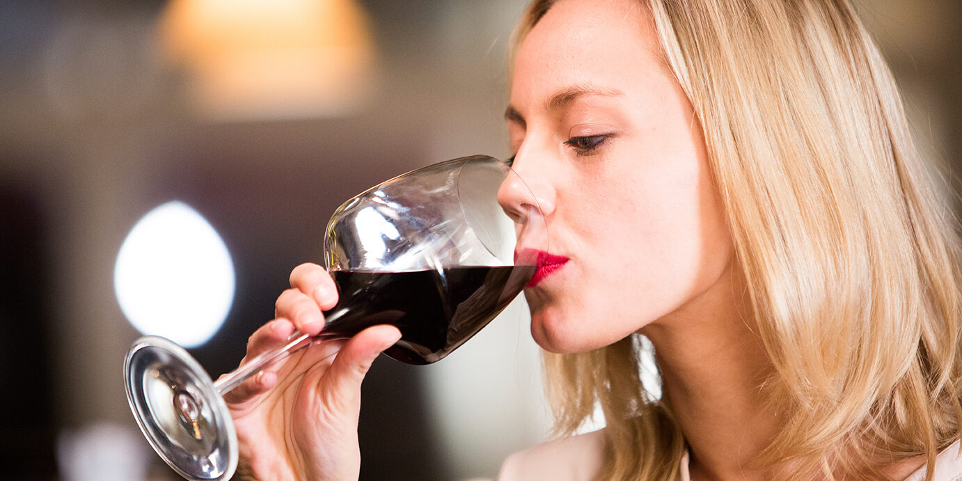Wine tasting Woman drinks red wine.