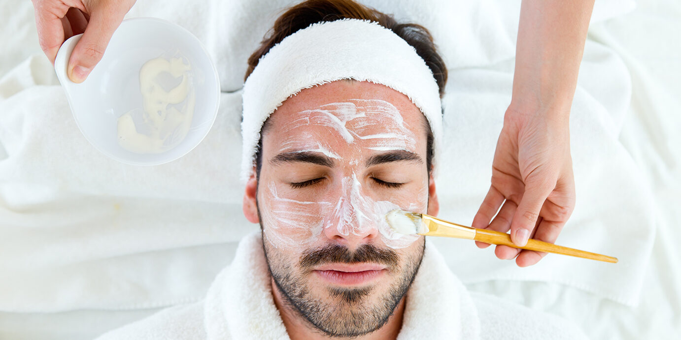 Man with clay facial mask in beauty spa. Portrait of man with clay facial mask in beauty spa.