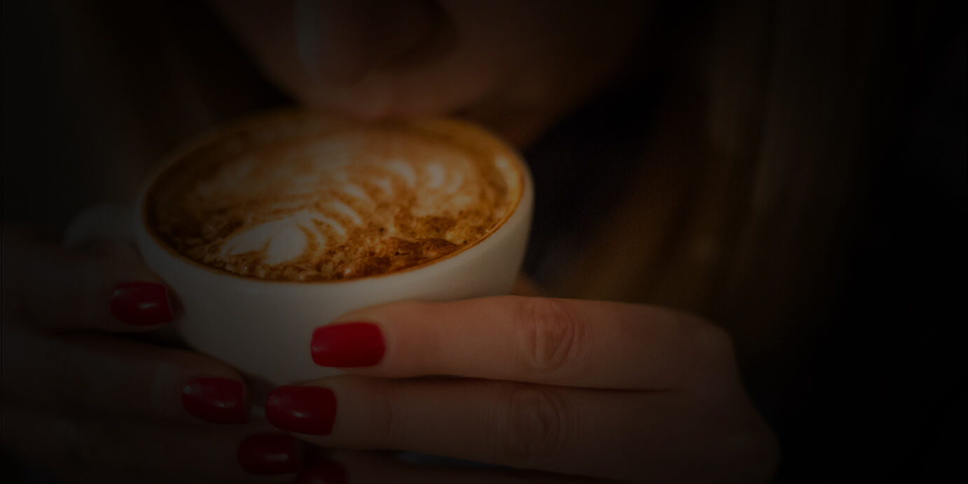 Pretty young woman drinking coffee Pretty young woman drinking coffee in cafe
