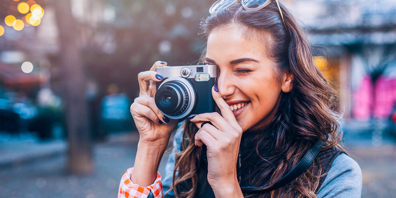 Young female photographer Young female photographer taking pictures outdoors.