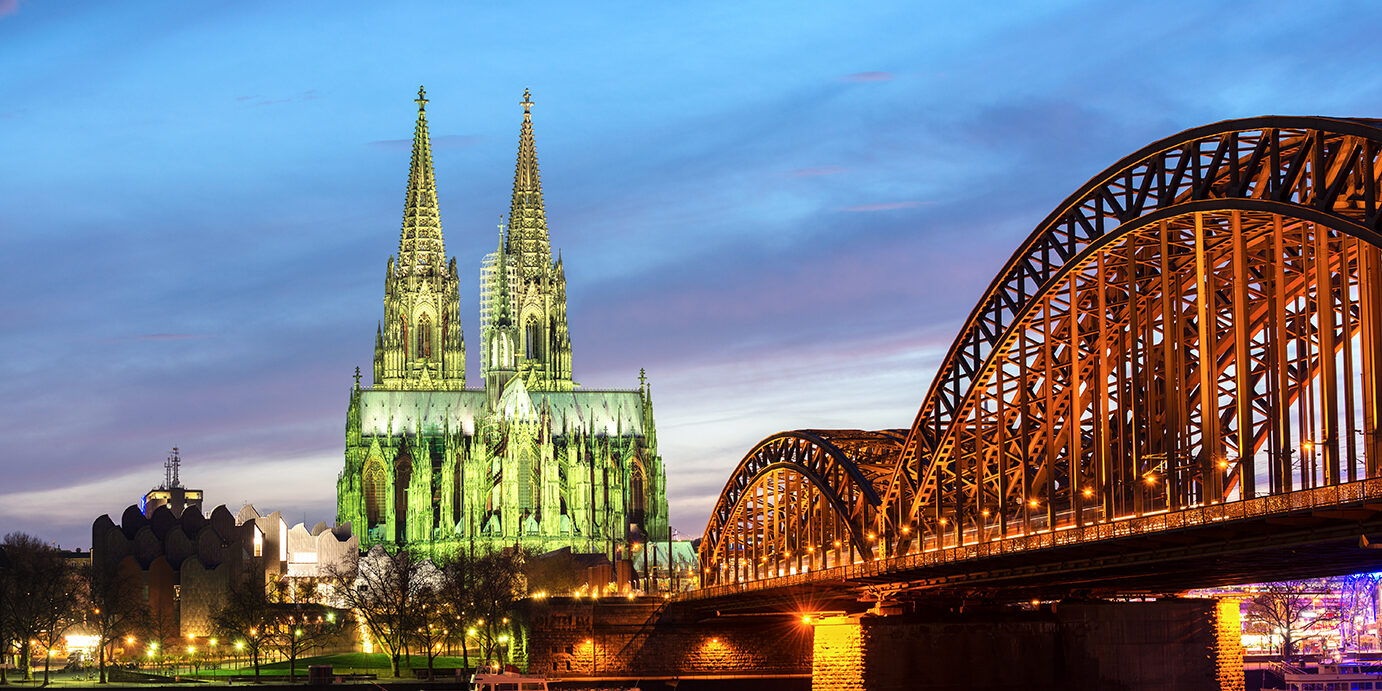 12119 Cologne cathedral and the Hohenzollern Bridge on the Rhein river at twilight, Germany