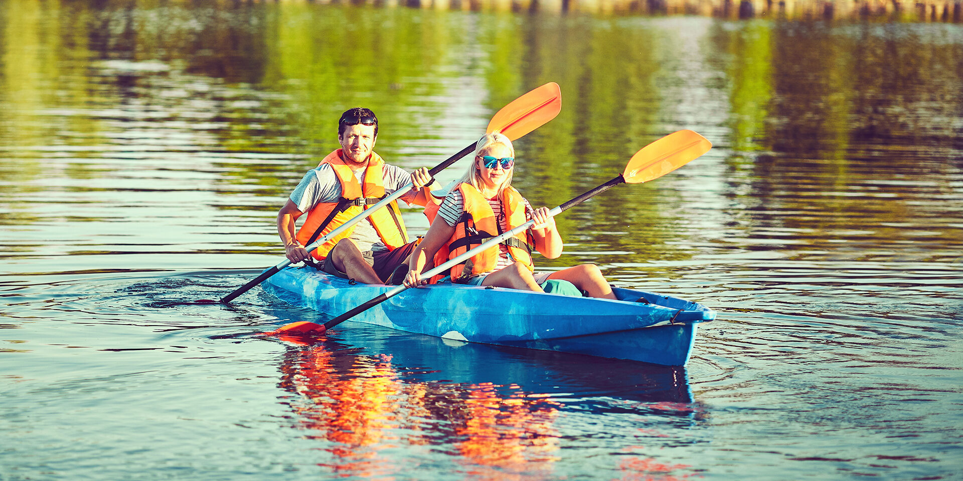 Wild nature and water fun on summer vacation. Camping and fishing. Kayaking and canoeing with family. Children on canoe. Family on kayak ride.