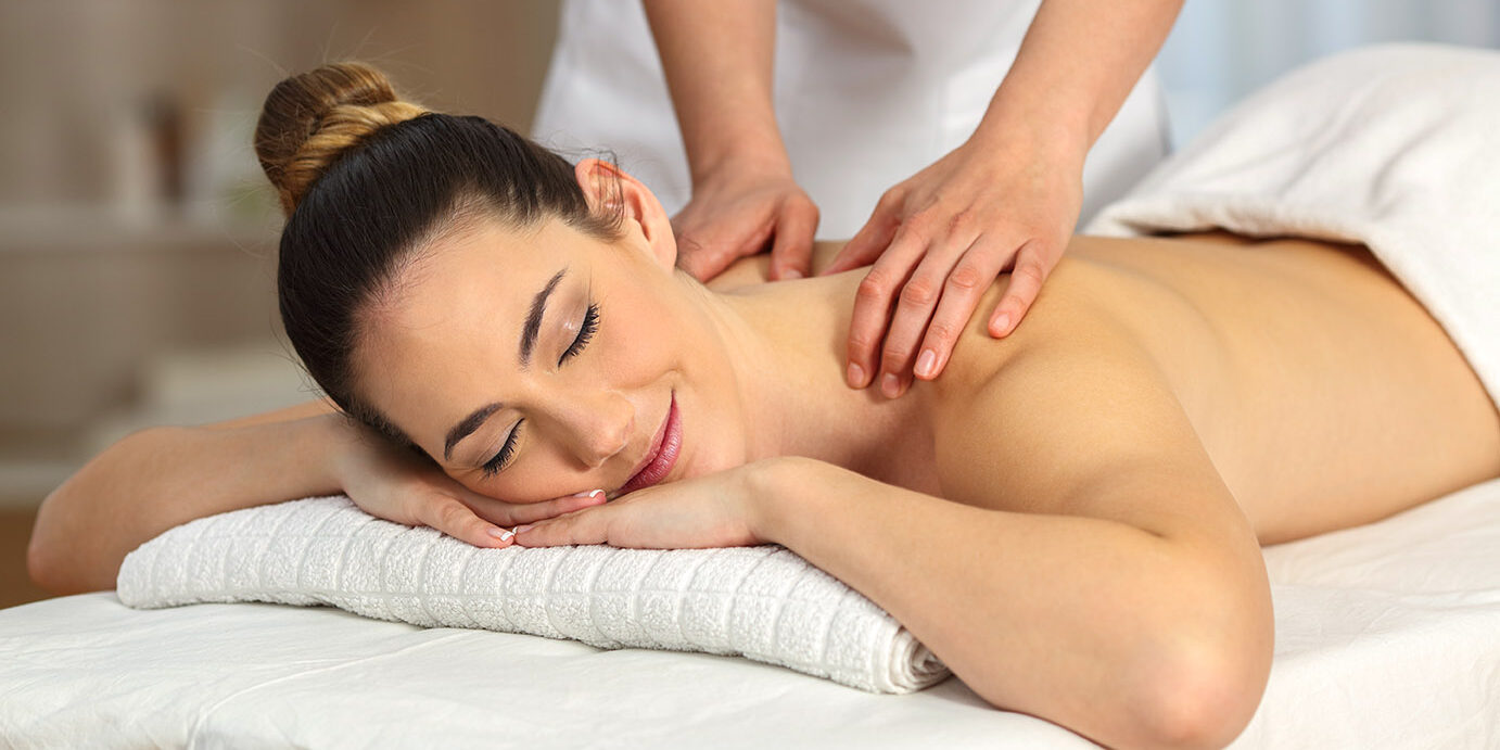 Relaxed woman receiving a back massage in a spa salon