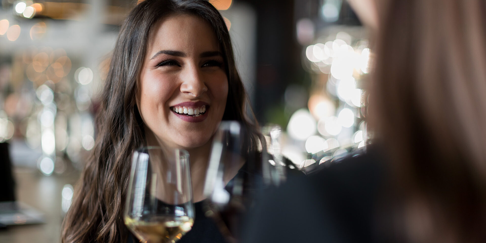 Wine toast Smiling coworkers toasting with wine in restaurant