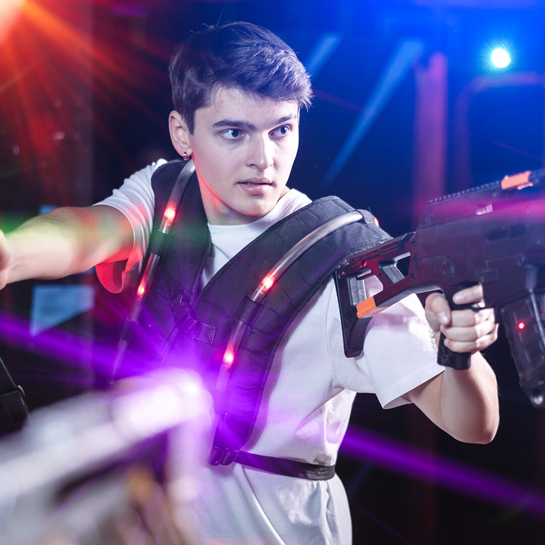 Boy running and dodging while playing lasertag