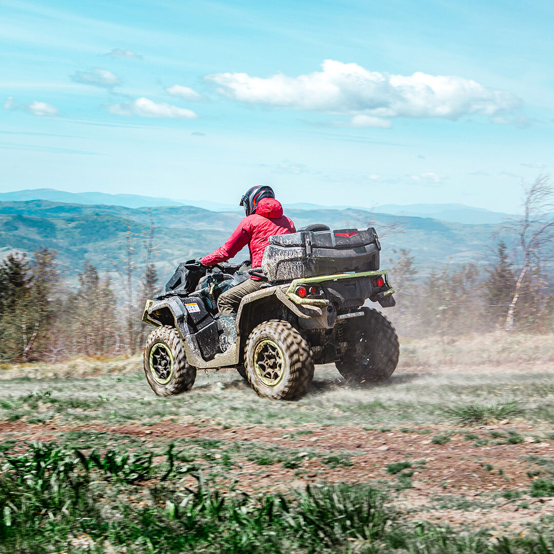 driving by mountain road at all-terrain vehicle. summer sunny day