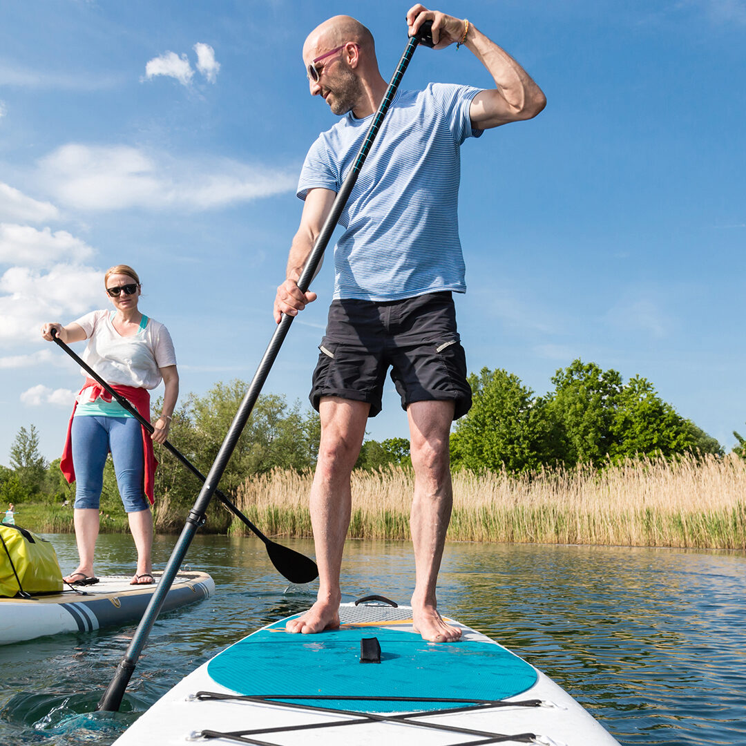 Couple on stand up paddle board on the lake, SUP