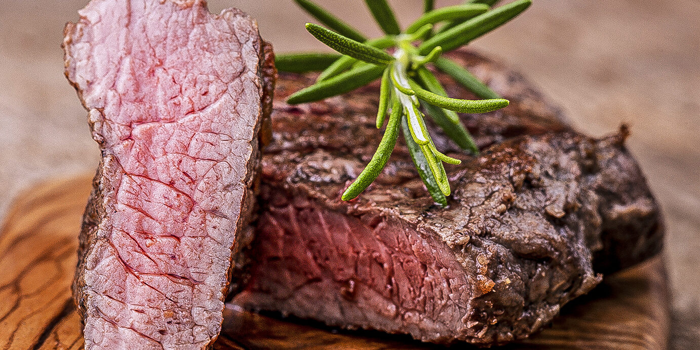 grilled steak grilled steak on wood with rosemary