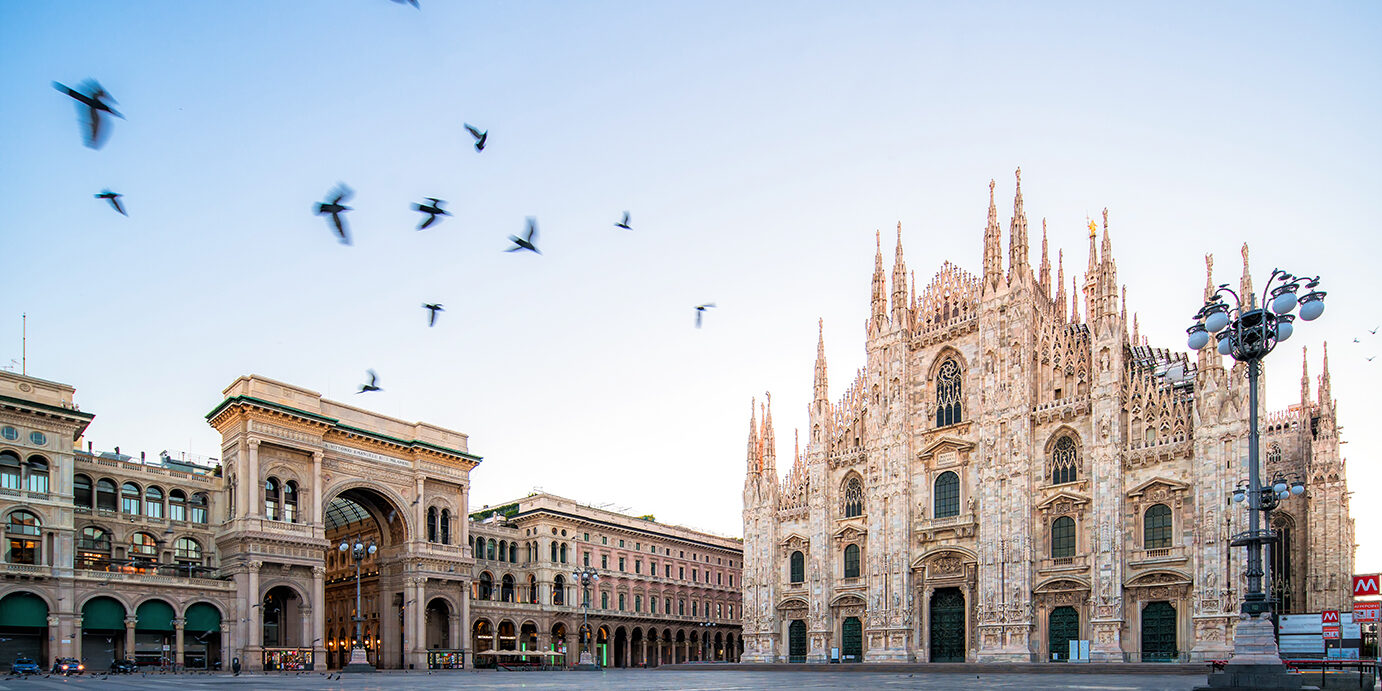the Piazza del Duomo at dawn Galleeria Vittorio Emenuele and Milan Cathedral square with flying pegion in the morning