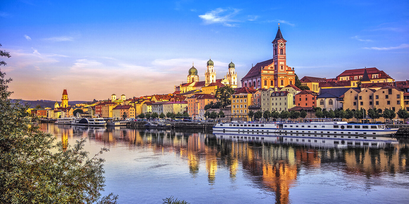 The waterfront and sightseeing boats in Passau at sunset.