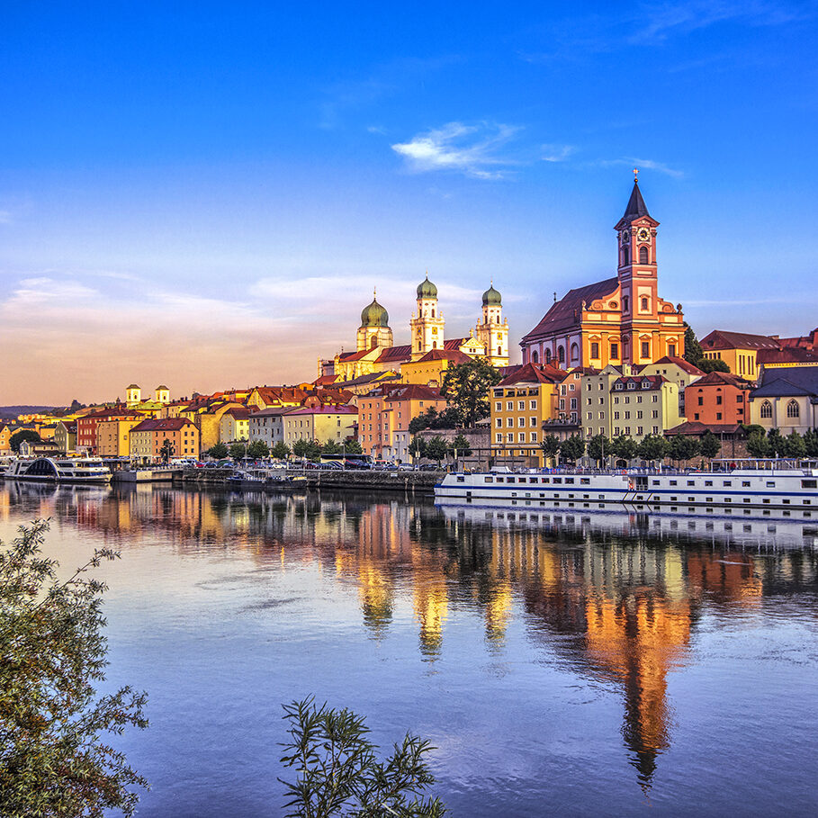 The waterfront and sightseeing boats in Passau at sunset.