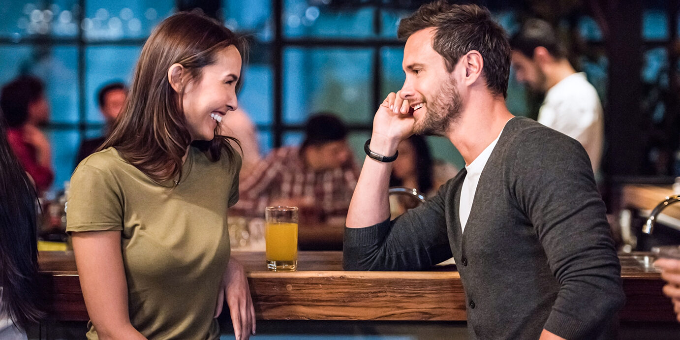 Romantic couple on a date at a bar Portrait of a romantic couple on a date at a bar having drinks and looking very happy