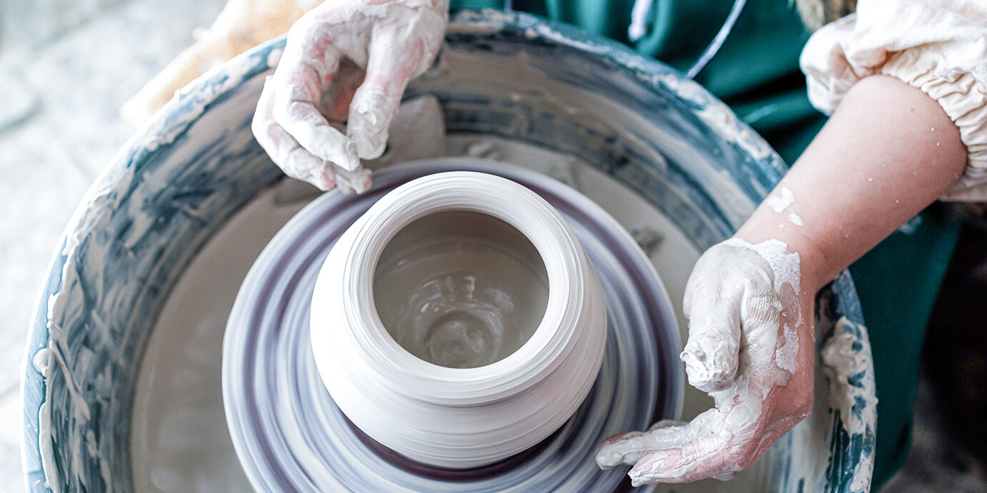 in the pottery workshop works master, dirty hands and a potter's wheel in the pottery workshop works master, dirty hands and a potter's wheel. work for calm and mental health