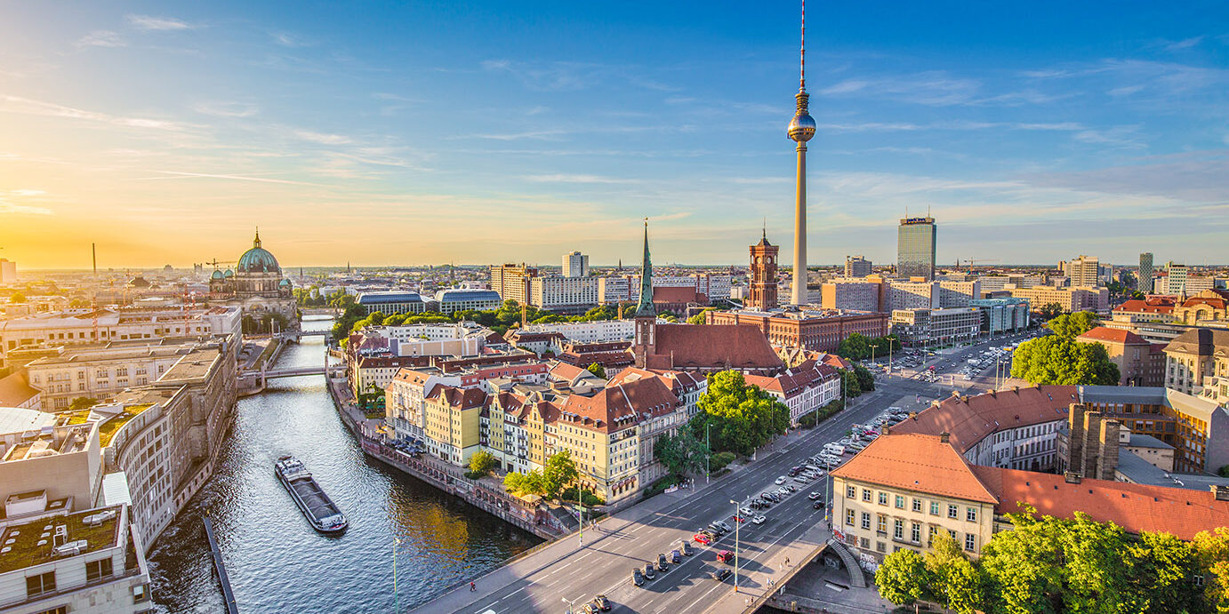 Aerial view of Berlin skyline with famous TV tower and Spree river in beautiful evening light at sunset, Germany.