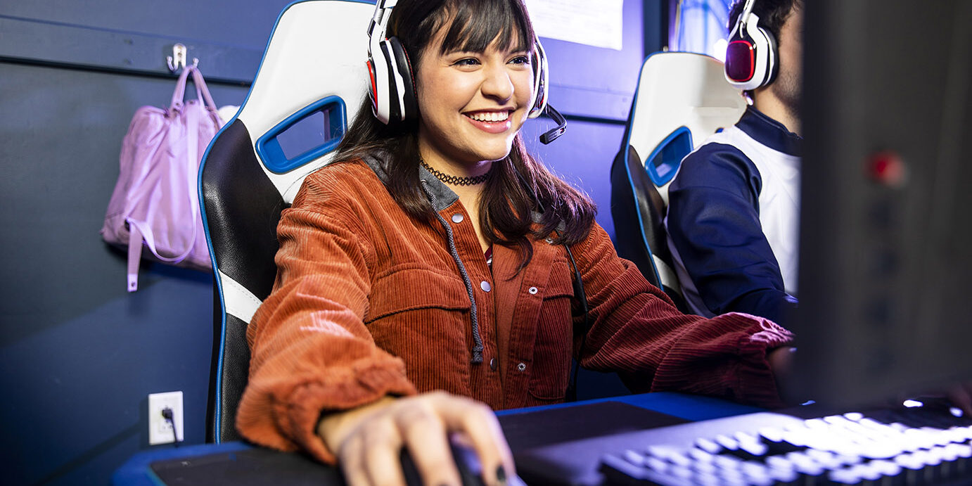 Female Gamer playing esports A young woman playing esports with her team