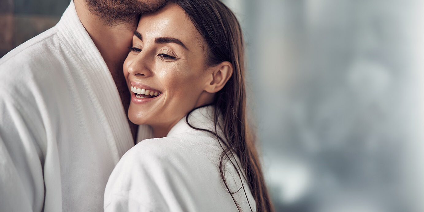 Lovely pair in white bathrobe hugging each other