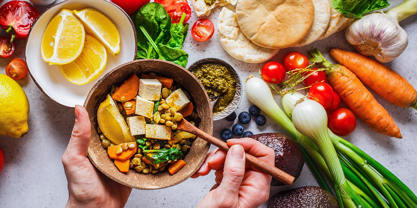 Healthy vegetarian food background. Vegetables, pesto and lentil curry with tofu. Healthy vegetarian food background. Vegetables, hummus, pesto and lentil curry with tofu.