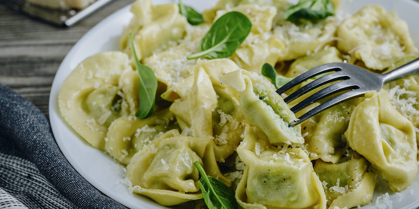 Italian ravioli pasta with spinach and ricotta on wooden background Italian ravioli pasta with spinach and ricotta on wooden rustic background