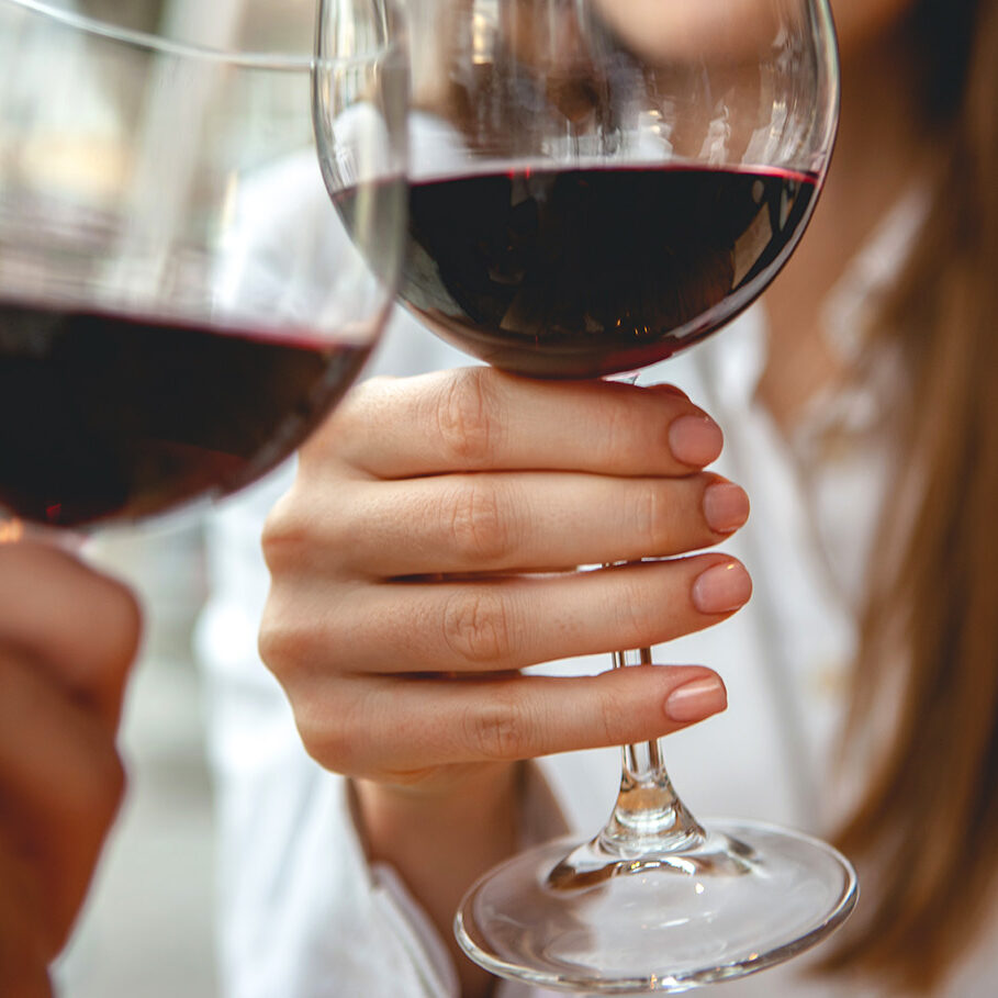 Friends toasting with red wine in outdoor restaurant