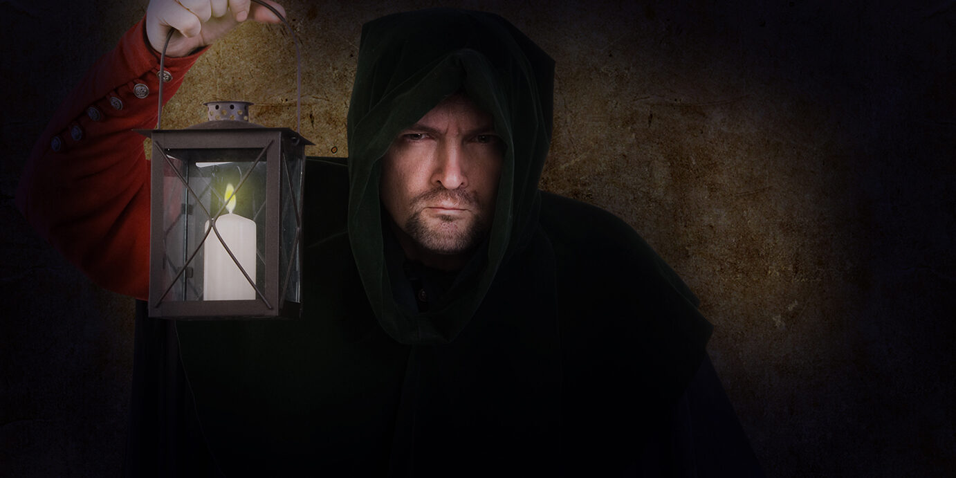 Night,Watchman,In,A,Medieval,Suit,And,Hood,With,A Night watchman in a medieval suit and hood with a lantern