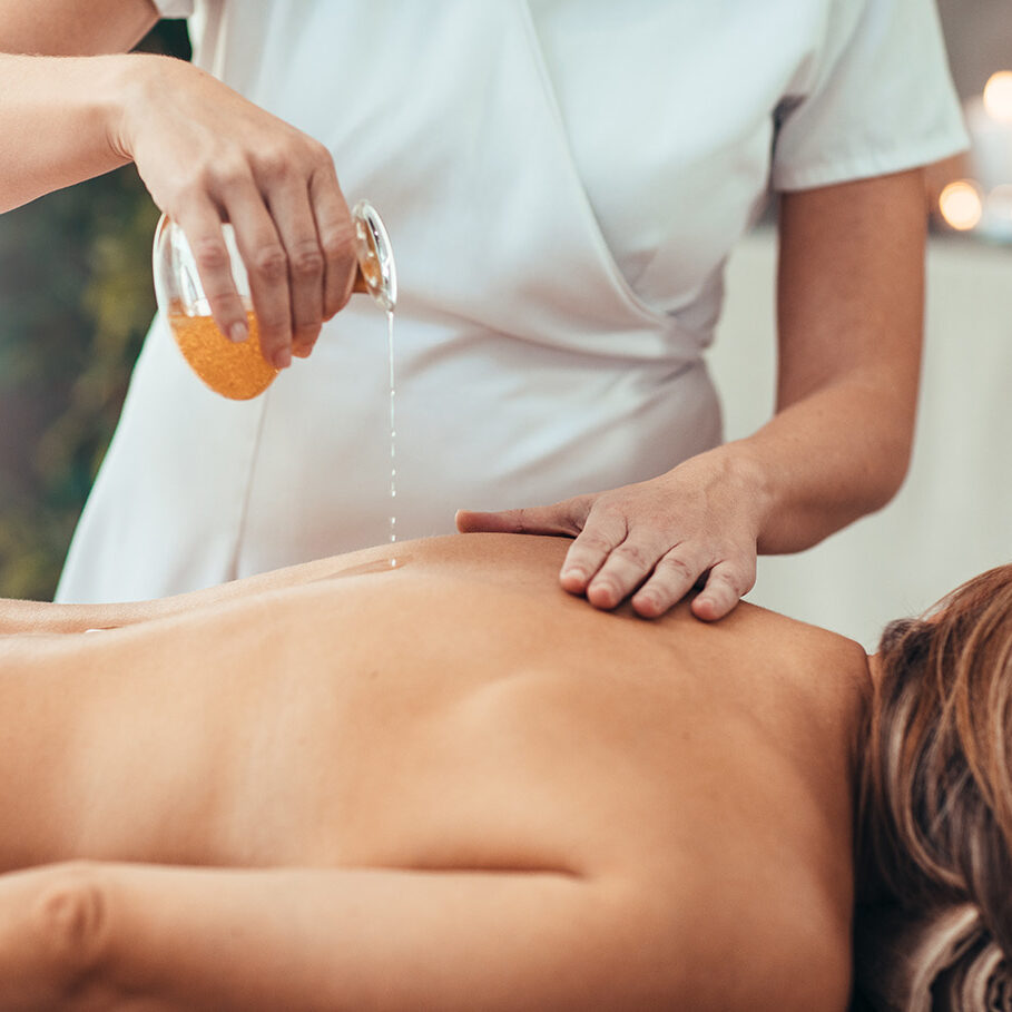 Woman relaxing during golden massage at the spa.