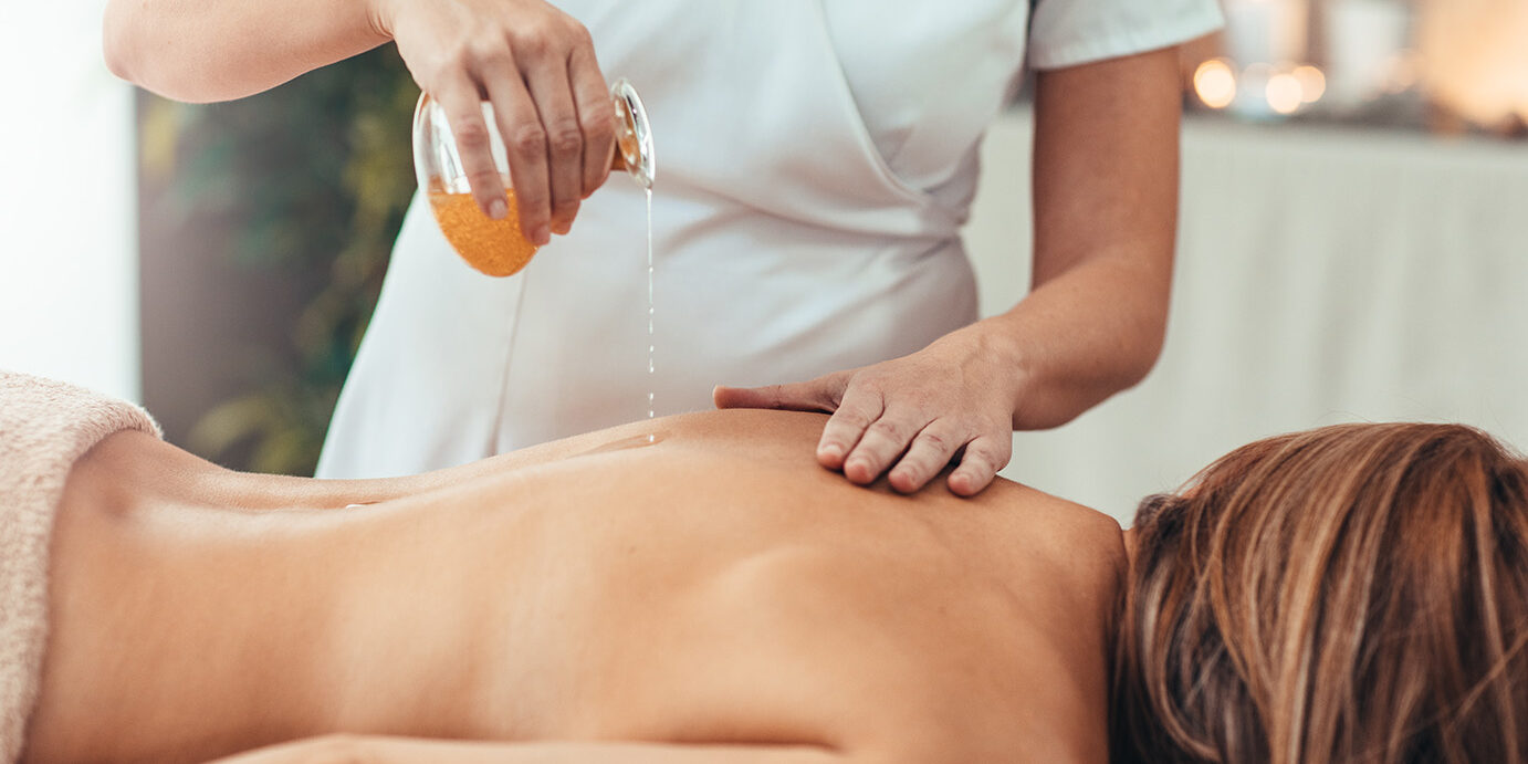 Woman Enjoy Golden Oil Massage Woman relaxing during golden massage at the spa.
