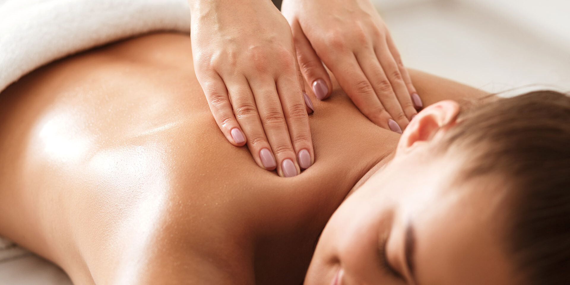 Young woman enjoying therapeutic neck massage in spa Young woman enjoying therapeutic neck massage in spa center, closeup