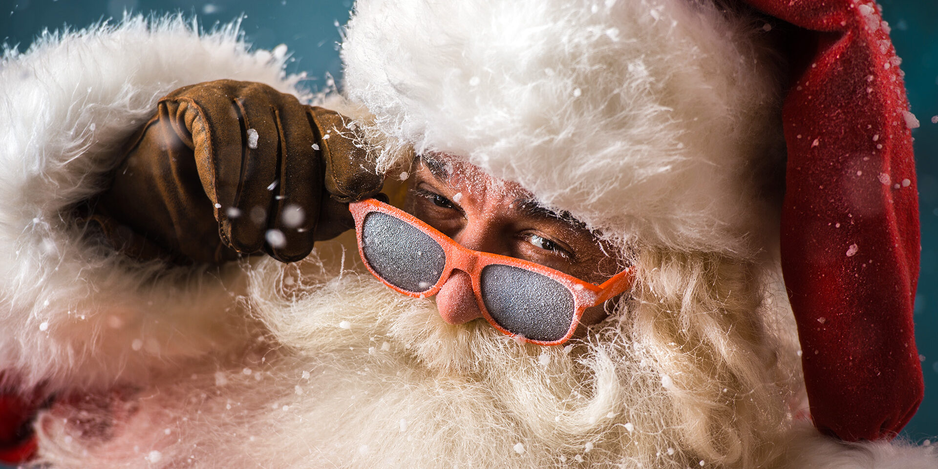 Santa,Claus,Wearing,Sunglasses,Dancing,Outdoors,At,North,Pole,In Santa Claus wearing sunglasses dancing outdoors at North Pole in snowfall. He is celebrating Christmas after hard work